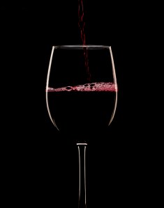 Red Wine being poured on a black background
